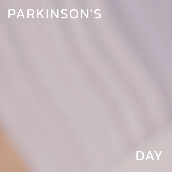 Composition of parkinson\'s disease day text and copy space on grey background. Parkinson\'s disease day and health awareness concept digitally generated image.