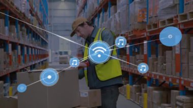 Animation of network of digital icons over caucasian male worker checking stock at warehouse. Global networking and transportation business concept