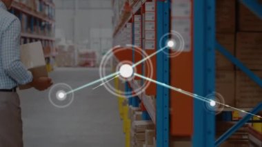 Animation of network of connections over caucasian male supervisor keeping box in shelf at warehouse. Global networking and transportation business concept
