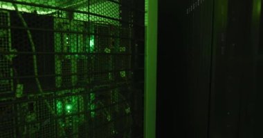 Animation of binary coding data processing and symbols against computer server room. Computer interface and business data storage technology concept