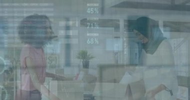 Animation of statistical data processing over two diverse women removing items from boxes at office. Moving and relocation concept