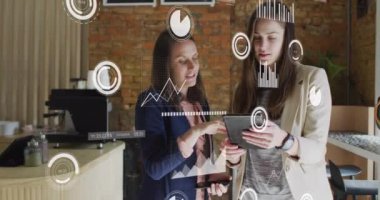 Animation of statistical data processing over two caucasian women discussing over digital tablet. Business data technology concept