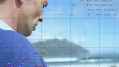 Animation of stock market data processing over caucasian man using smartphone at the beach. Global economy and business technology concept
