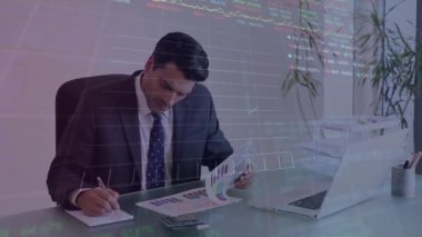 Animation of stock market data processing over caucasian businessman reading documents at office. Global economy and business technology concept