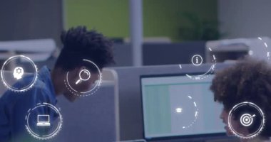 Animation of network of icons over diverse business people. Global networks, business, finances, computing and data processing concept digitally generated video.