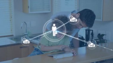 Animation of network of connections with icons over diverse father and son using tablet. Global connections, technology and digital interface concept digitally generated video.