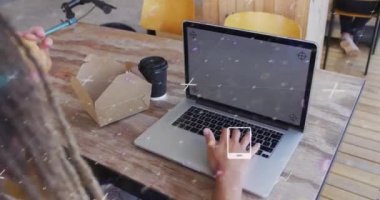 Animation of data processing with icons over man using laptop. Global networks, business, finance, computing and data processing concept digitally generated video.