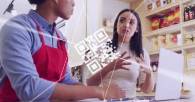 Animation of qr code and data processing over diverse people using laptop in shop. Global shopping, business, finance, computing and data processing concept digitally generated video.