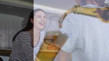 Animation of glass with beer over diverse friends having drink in bar. Leisure, free time and celebration concept digitally generated video.