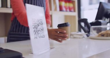 Animation of qr code scanning over man paying with smartphone in shop. Global shopping, business, finance, computing and data processing concept digitally generated video.