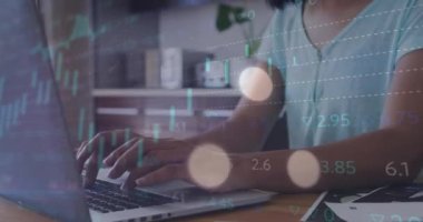 Animation of financial data processing over biracial businesswoman using laptop. Global business, finance, computing and data processing concept digitally generated video.