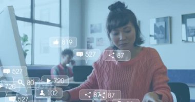 Animation of media icons over diverse business people working in office. Global business and digital interface concept digitally generated video.