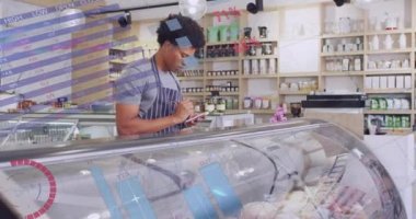 Animation of numbers and data processing over biracial man working in shop. Global shopping, business, finance, computing and data processing concept digitally generated video.