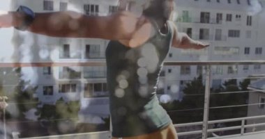 Animation of glowing lights over biracial woman practicing yoga. Health and fitness, active lifestyle concept digitally generated video.