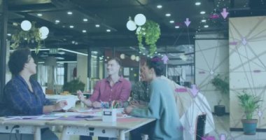 Animation of media icons over diverse business people working in office. Global business and digital interface concept digitally generated video.