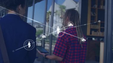 Animation of network of connections with icons over man using tablet. Global networks, business, finance, computing and data processing concept digitally generated video.