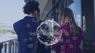 Animation of network of connections with globe and icons over man using tablet. Global networks, business, finance, computing and data processing concept digitally generated video.