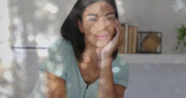 Animation of light spots over portrait of biracial woman. Lifestyle, fashion and light concept digitally generated video.