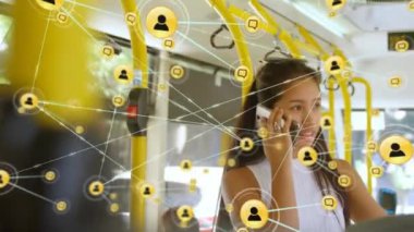 Animation of network of digital icons over asian woman talking on smartphone in the bus. Global networking and business technology concept