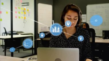 Animation of network of digital icons over caucasian woman talking on smartphone at office. Global networking and business technology concept