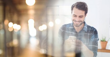 Composition of smiling caucasian businessman using smartphone with copy space. global technology and communication concept digitally generated image.