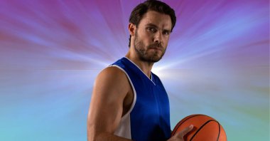 Composition of male basketball player holding basketball with copy space. sport and competition concept digitally generated image.