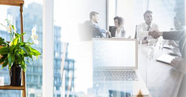 Composition of happy diverse business team shaking hands in meeting room with motion blur. global business, partnership and success concept digitally generated image.