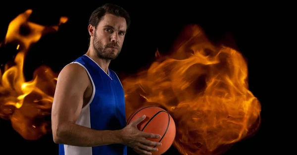 Složení Mužského Basketbalisty Držícího Míč Nad Plameny Černém Pozadí Sport — Stock fotografie