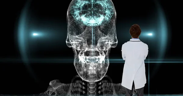 Composition of male doctor using virtual screen with skull model. global medicine and digital interface concept digitally generated image.