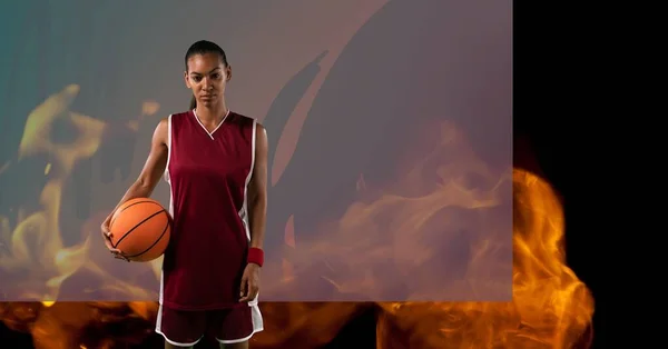 Composition Female Basketball Player Standing Holding Ball Flames Grey Background — Stock fotografie