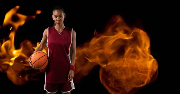 Composition Female Basketball Player Standing Holding Ball Flames Black Background — Stock fotografie