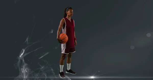Composition of female basketball player holding basketball with copy space. sport and competition concept digitally generated image.
