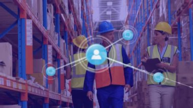 Animation of network of icons over caucasian male and female supervisor discussing at warehouse. Global networking and logistics business technology concept