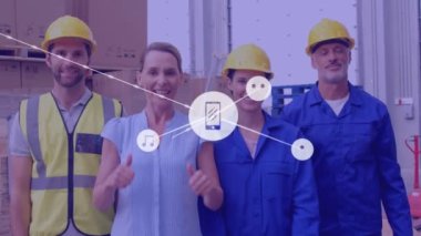 Animation of network of icons over diverse supervisors and workers showing thumbs up at warehouse. Global networking and logistics business technology concept