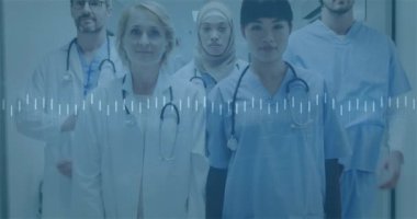 Animation of financial data processing over diverse doctors at hospital. Global medicine, healthcare, finances and digital interface concept digitally generated video.