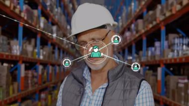 Animation of network of connections with icons over caucasian worker in warehouse. Global connections, shipping, delivery and digital interface concept digitally generated video.
