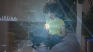 Animation of network of connections with data processing over african american woman using laptop. Global business, finances and digital interface concept digitally generated video.