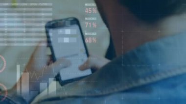 Animation of statistical data processing over rear view of man using smartphone. Global networking and business data technology concept
