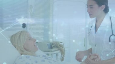 Animation of network of connections over caucasian female doctor and patient at hospital. Global medicine, connections and digital interface concept digitally generated video.