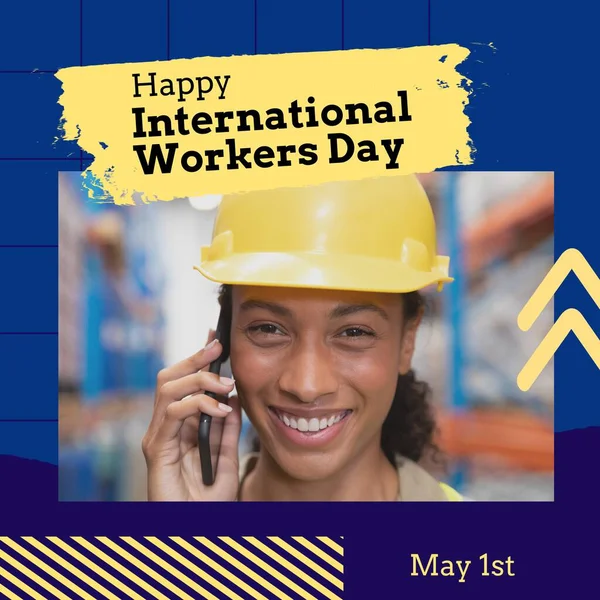 Composition of international workers day text over african american female worker in warehouse. International workers day and celebration concept digitally generated image.