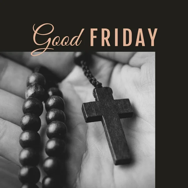 Image of good friday text over hand holding rosary with cross and bible. Good friday, faith and celebration concept digitally generated image.