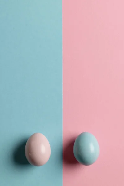 Image of pink and blue easter eggs and copy space on pink and blue background. Easter, religion, tradition and celebration concept.