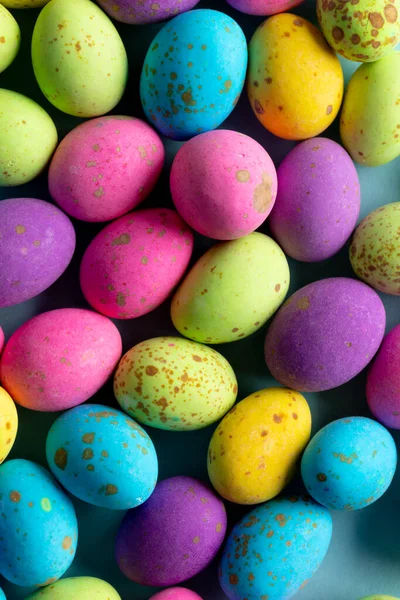 Image of multi coloured easter eggs on blue background. Easter, religion, tradition and celebration concept.