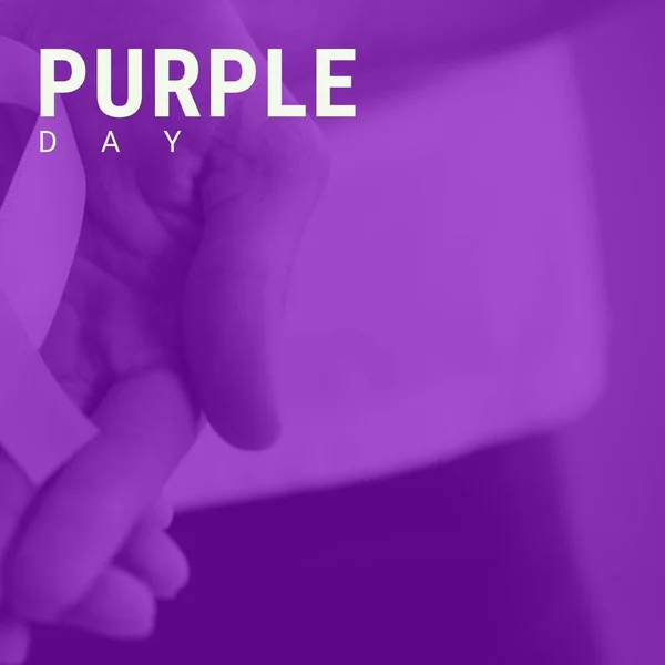 Image of purple day text over hands holding epilepsy purple ribbon. Purple day and celebration concept digitally generated image.