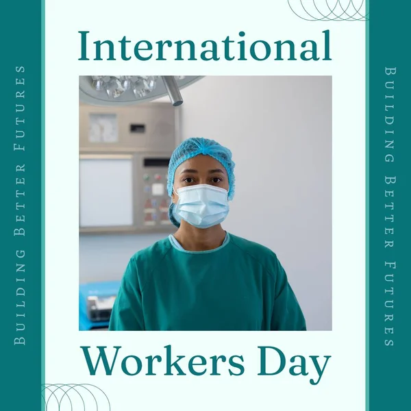 Composition of international workers day text over biracial female doctor with face mask. International workers day and celebration concept digitally generated image.