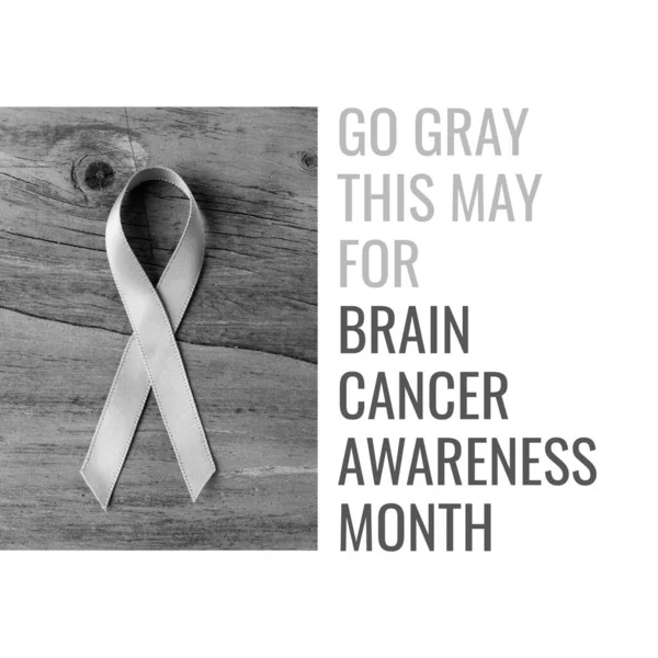 Composition of go gray this may for brain cancer awareness month text over grey ribbon. Brain cancer awareness month concept digitally generated image.