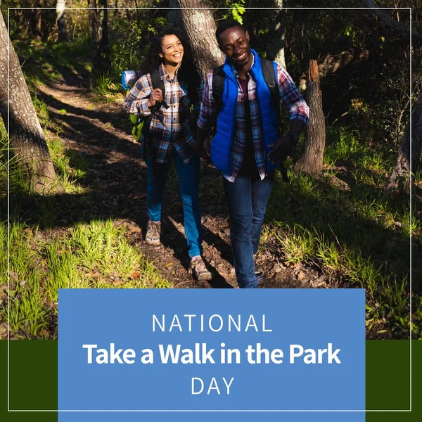 National take a walk in the park day text over happy diverse couple walking in park. National take a walk in the park day and celebration concept digitally generated image.