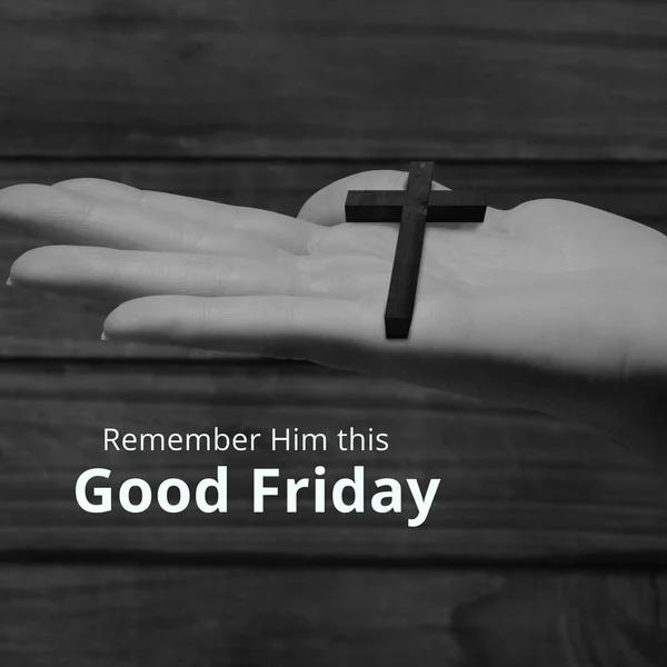 Image of good friday text over hand holding cross. Good friday and faith concept digitally generated image.