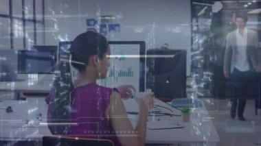 Animation of data processing over biracial businesswoman working in office. Global business, finances, computing and data processing concept digitally generated video.