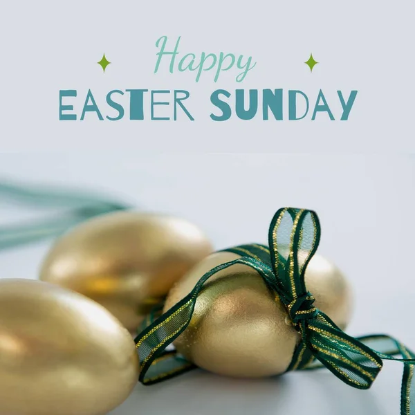 Image of happy easter sunday text over chocolate easter eggs with band. Easter sunday and celebration concept digitally generated image.